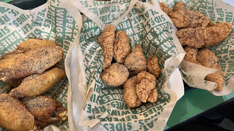 Baskets of Wingstop Lemon Pepper flavored chicken