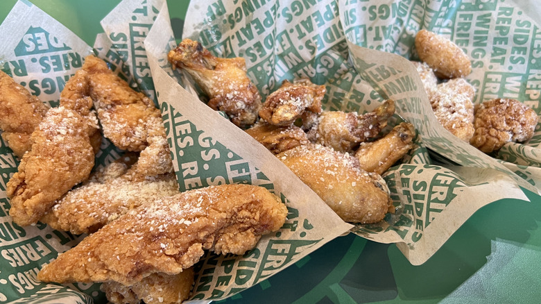 Baskets of Wingstop Garlic Parmesan flavored chicken