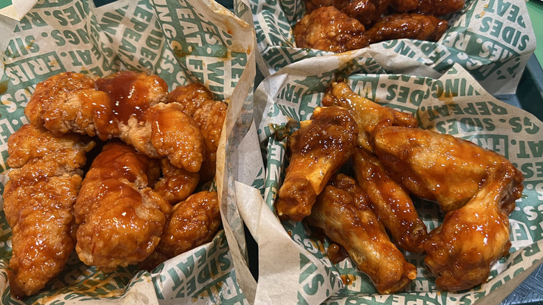 Baskets of Wingstop Mango Habanero flavored chicken