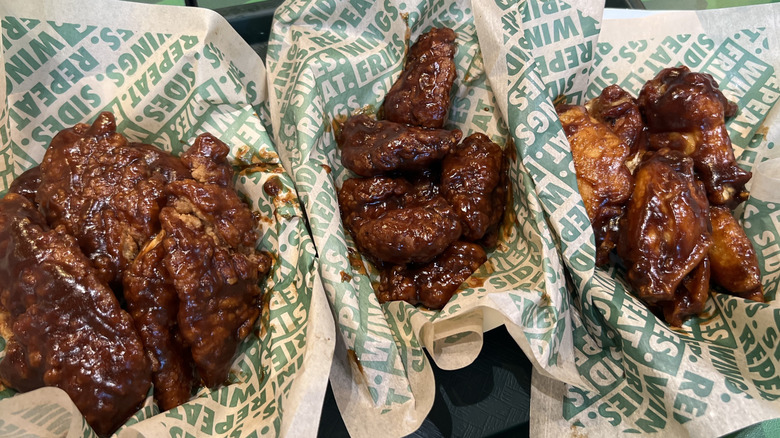 Baskets of Wingstop Hickory Smoke BBQ flavored chicken