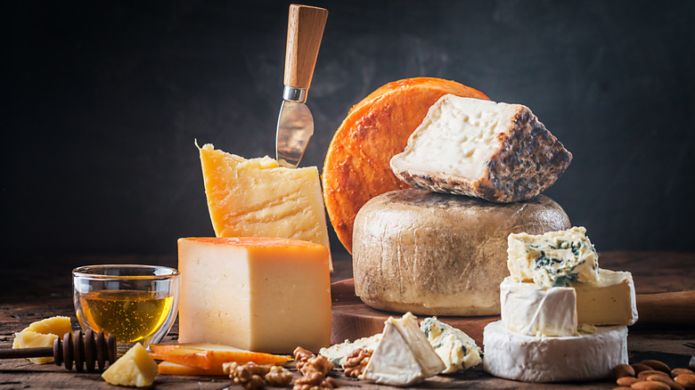 Different kinds of cheeses on a wooden board