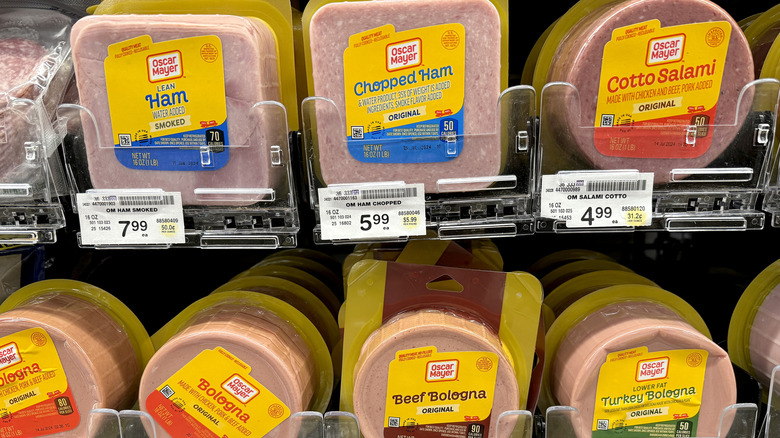 Packages of deli meat on the shelves at the grocery store