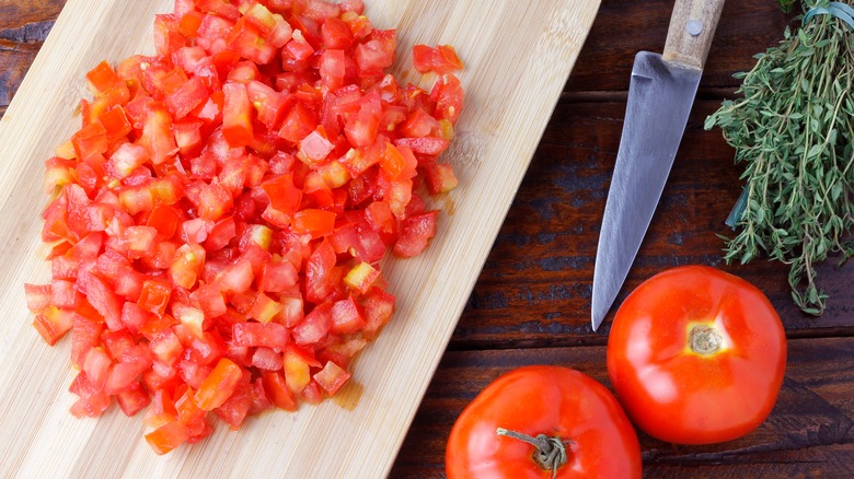 Diced tomatoes on wooden cutting board