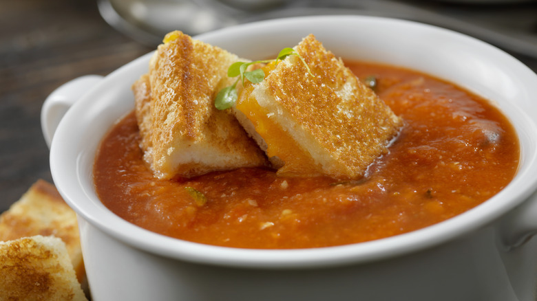 Tomato soup with chopped grilled cheese in bowl