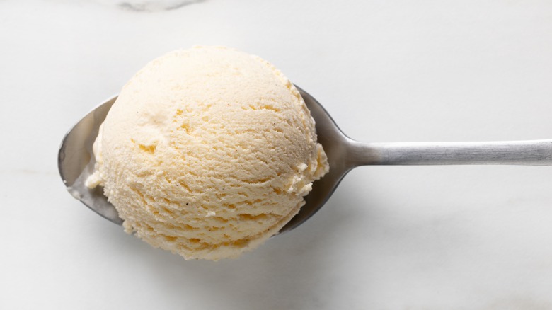 A scoop of vanilla ice cream on a spoon