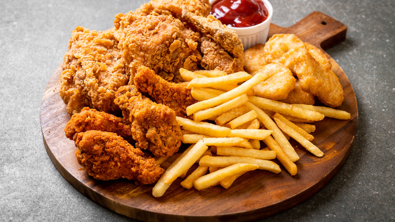 Fried chicken with french fries and nuggets on a table.