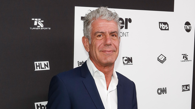 Anthony Bourdain posing on the red carpet.