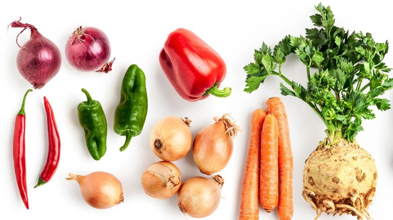 variety of vegetables laying flat on white background