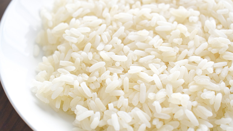 Cooked parboiled rice on a white plate