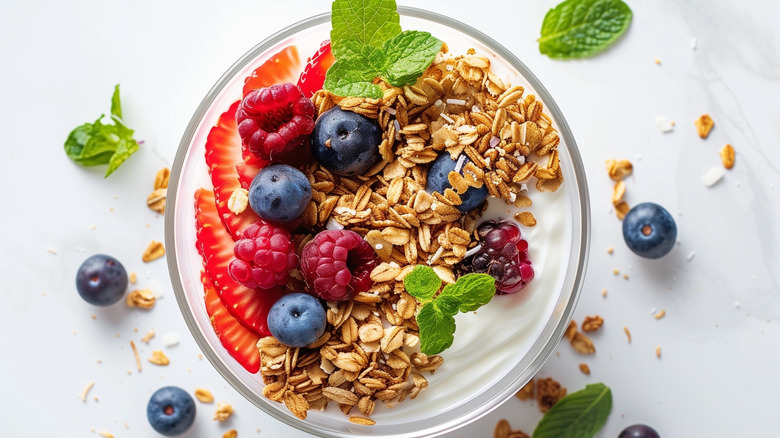 Top view of yogurt with granola, berries, and other toppings