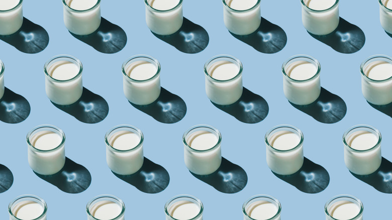 aesthetic pattern of glasses of milk on a blue background