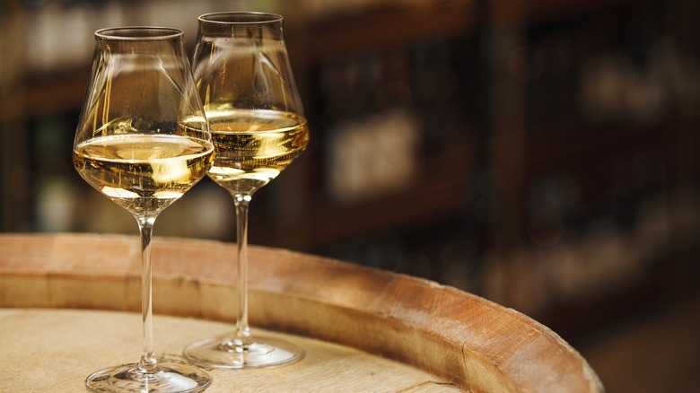 white wine glasses on barrel