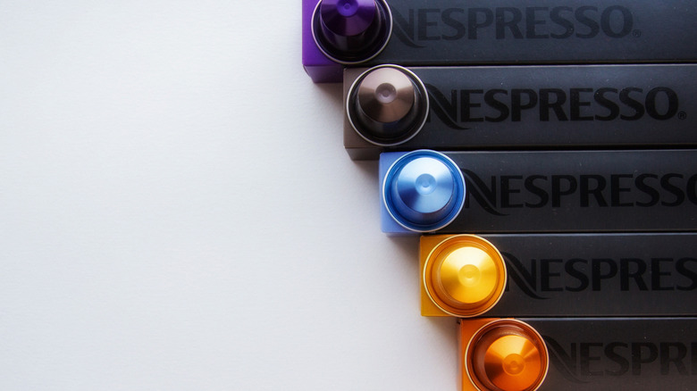 Multicolored Nespresso pods on top of its boxes