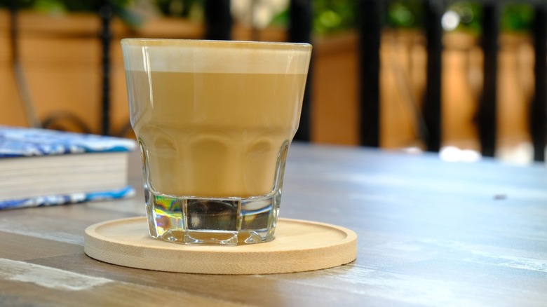 A cortado served in Gibraltar glass.