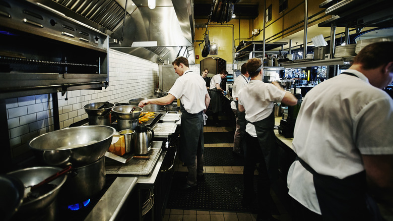 Multiple chefs working inside a busy resturant kitchen