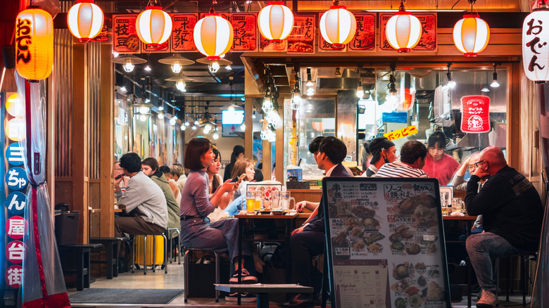 People sitting and socializing at an eatery in Japan