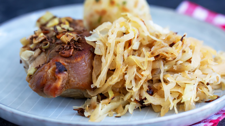 roast pork with sauerkraut on a white plate