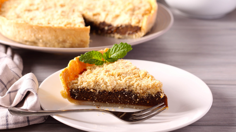 slice of shoofly pie on white plate with fork