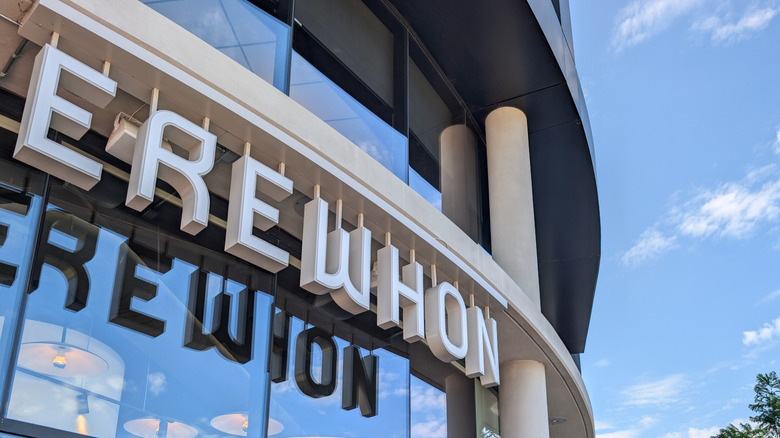 Erewhon grocery store entrance reflecting blue sky