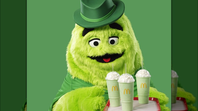 Grimace and Uncle O'Grimacey holding Shamrock Shakes