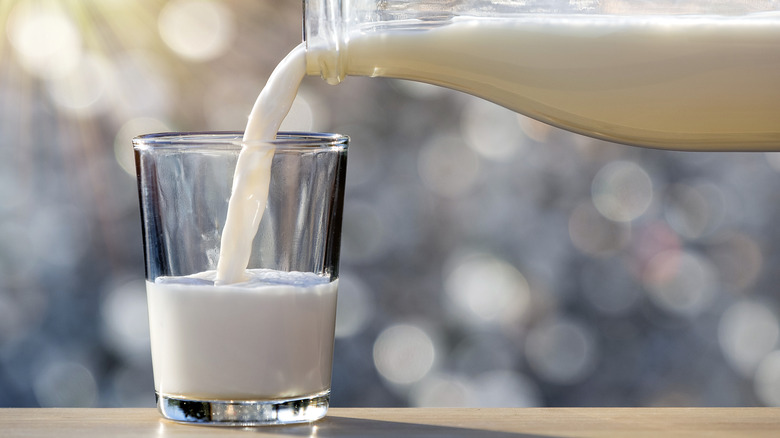 Milk pouring from a bottle to a glass