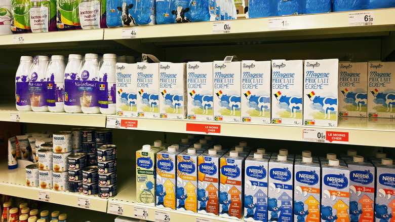 Boxes of milk on a shelf in a grocery store