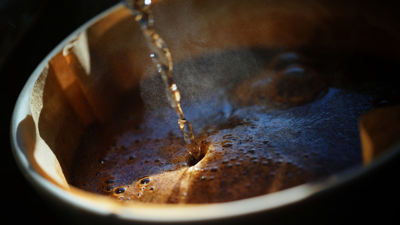 Water being poured into a coffee filter.