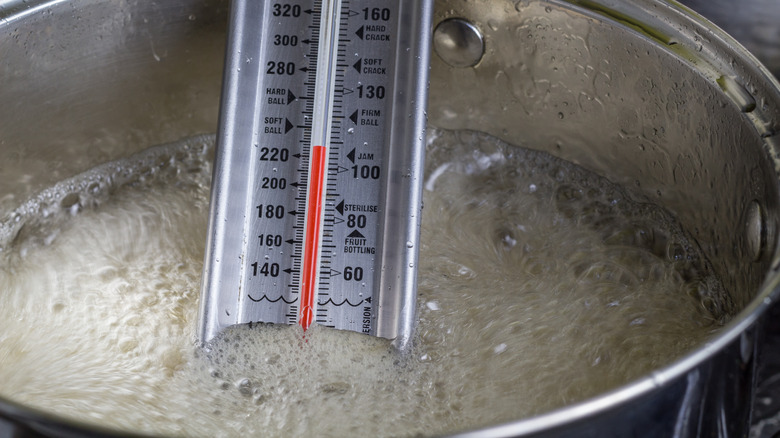 candy thermometer in boiling syrup