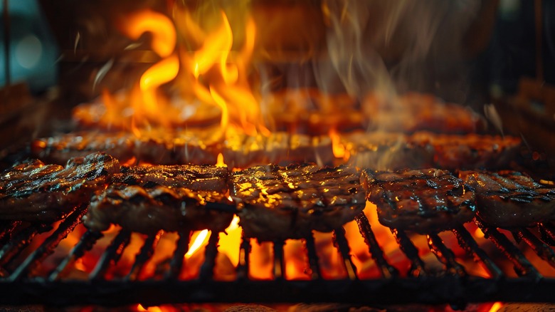 steak on grill with flames