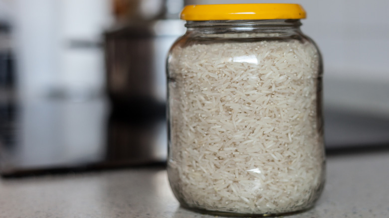 Uncooked rice in a glass jar with yellow lid