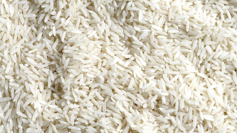 A pile of uncooked long-grain white rice