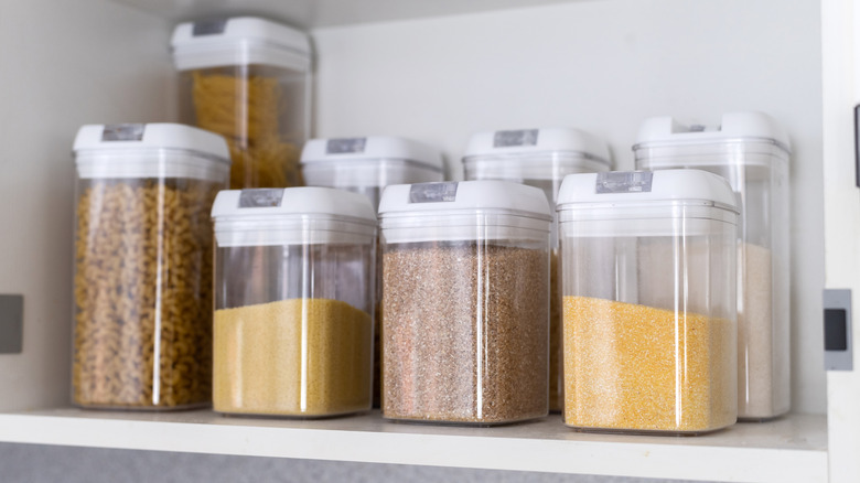 grains and cereals stored in clear airtight containers in a pantry