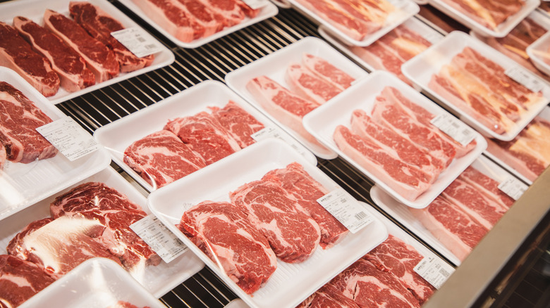 Multiple packaged raw beef steaks next to one another