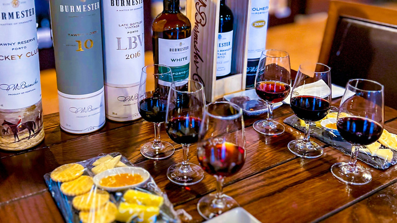 Bottles, glasses of port, and cheese for port tasting