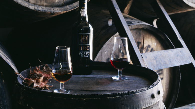 Glasses of port on top of a barrel