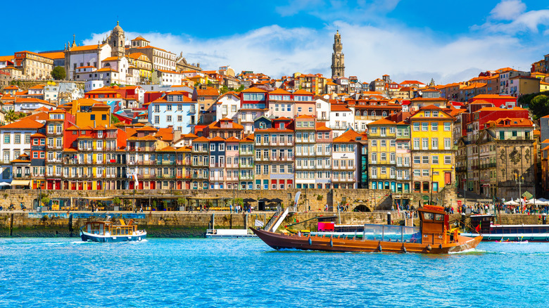 Boats passing by the city of Porto