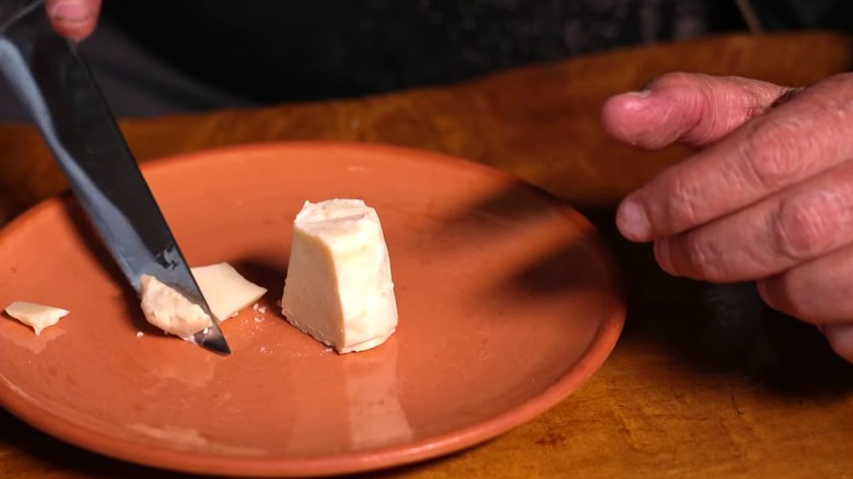 A wedge of pule cheese on a plate.