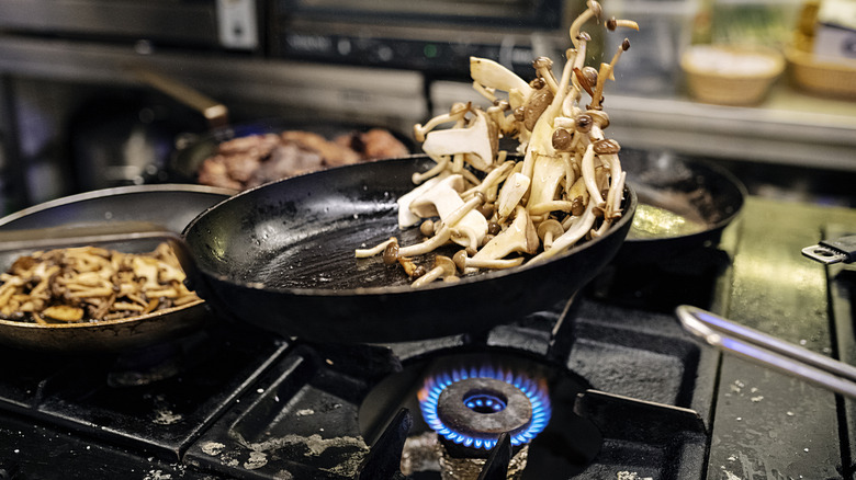 Cooking a variety of mushrooms in a pan