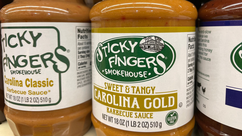 Bottles of South Carolina signature barbecue sauces sitting on a grocery store shelf.