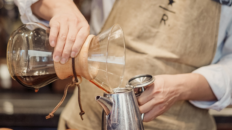 Barista pours a coffee at a Starbucks reserve roastery