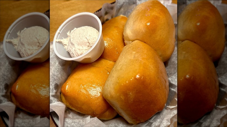 Texas Roadhouse bread rolls in a basket with butter