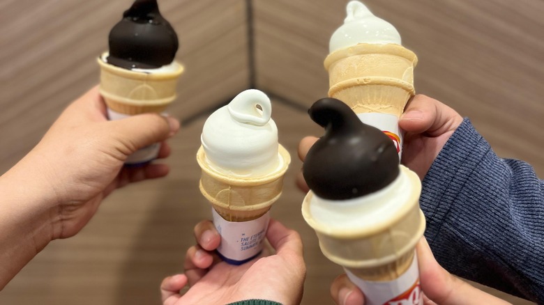 hands holding dairy queen cones