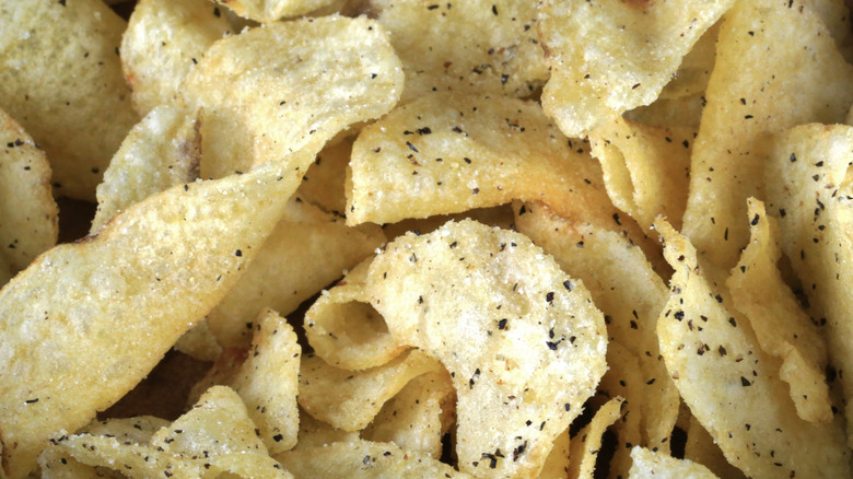 Close up of a bunch of kettle chips with pepper flakes