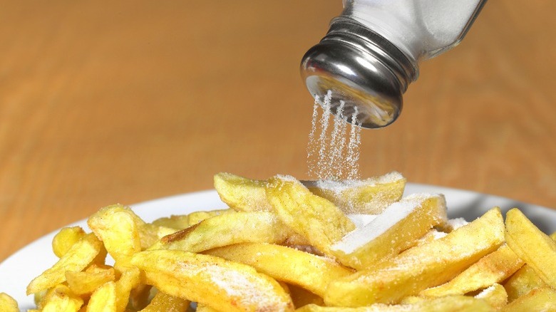 salt shaker over fries