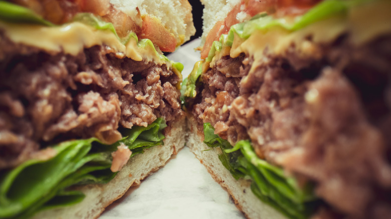 Close-up of a cooked burger sliced in half