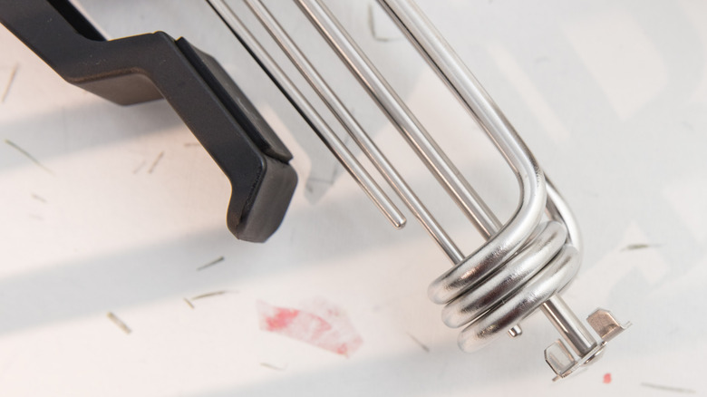 The tip of a sous vide instrument on a white counter