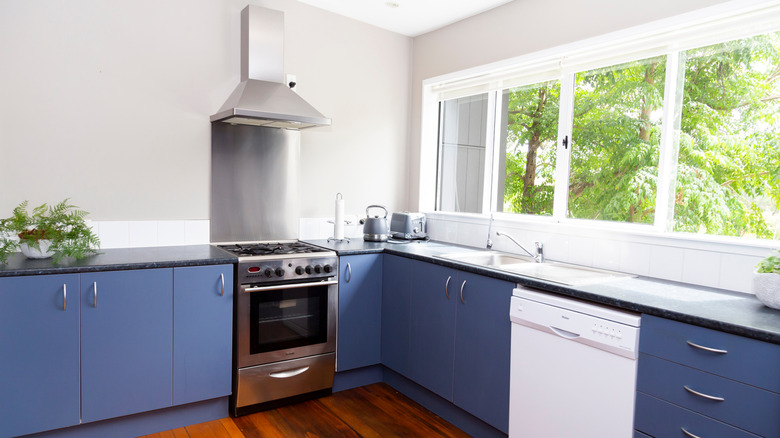 Modern kitchen with a stainless steel range that has a bottom drawer