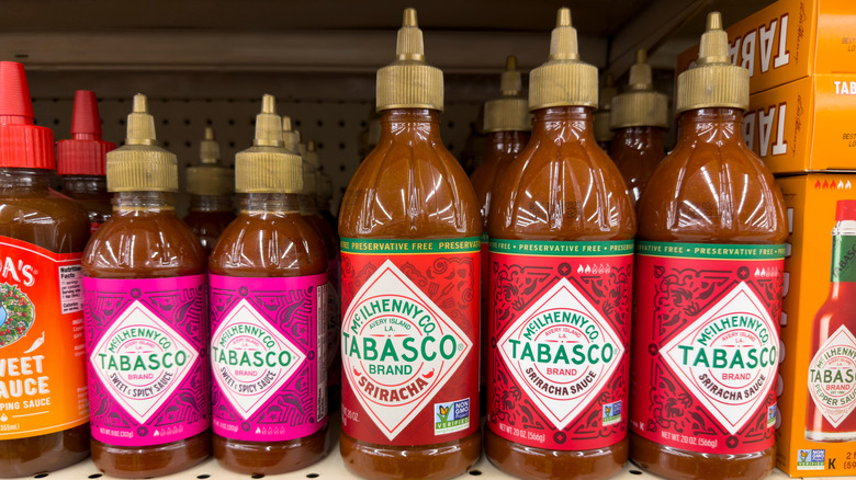 sriracha bottles on a shelf