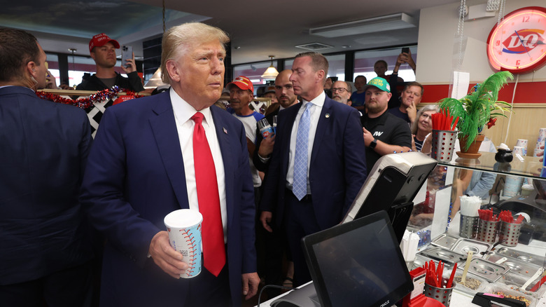 Donald Trump holding a milkshake at Dairy Queen