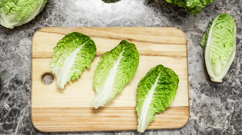 lettuce leaves on wooden chopping board